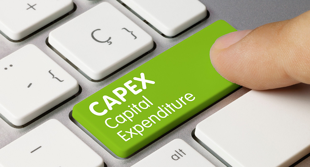 A person touching the keyboard with text over it, CAPEX and Capital Expenditure